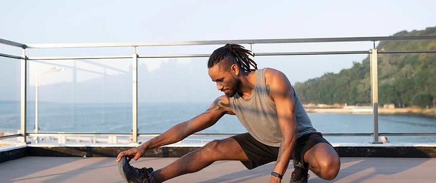 Man performing mobility exercises as part of a full-body movement routine