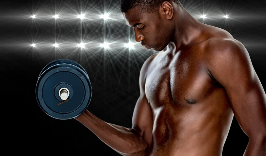 Athlete performing strength training with a dumbbell at the gym