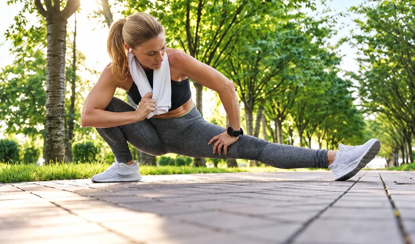 oman stretching outdoors after a spring workout